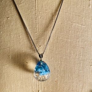 Color cloud glass pendant on silver chain.